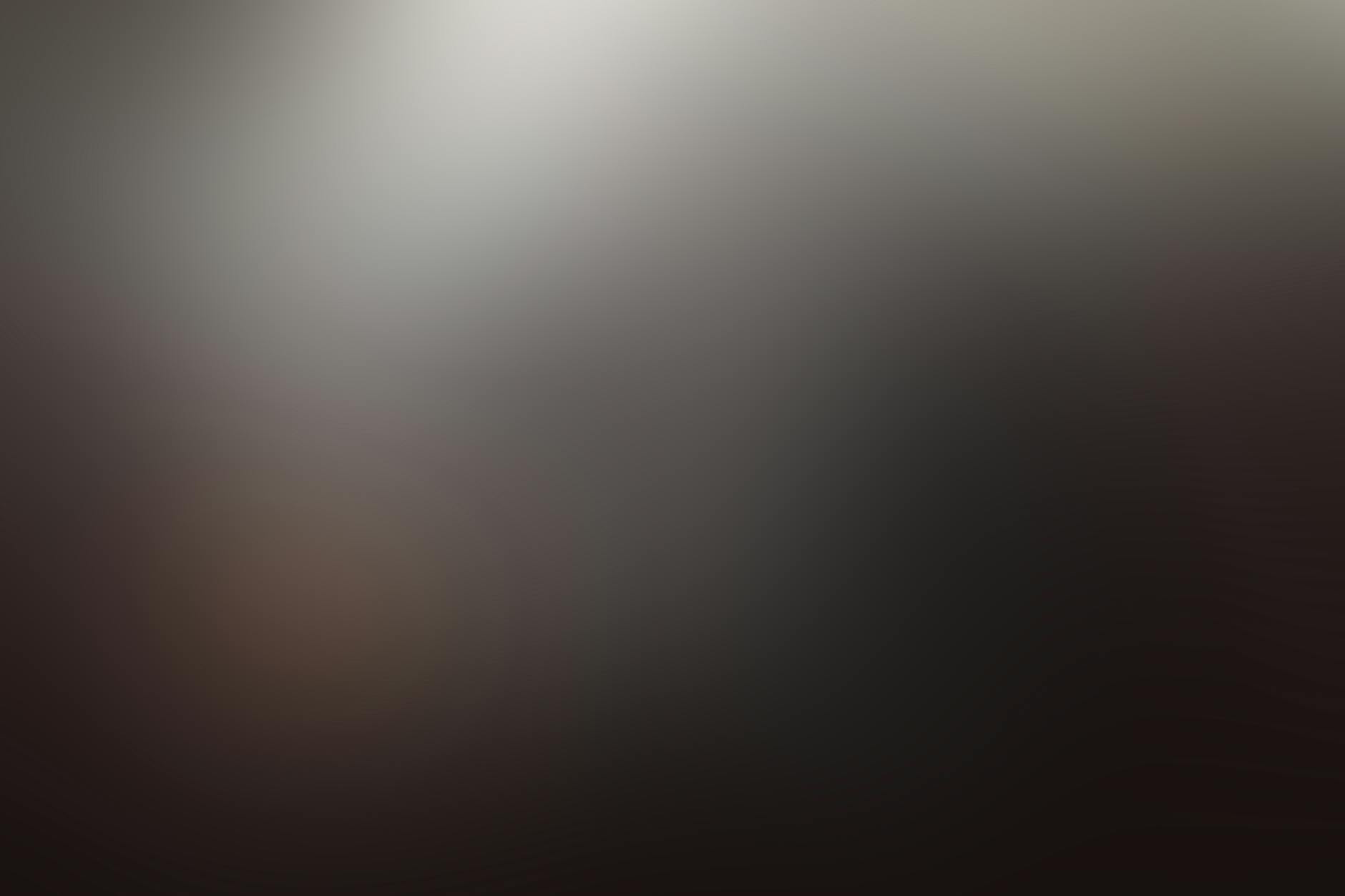 A dark and moody abstract image with soft gradient blur, conveying mystery and depth.