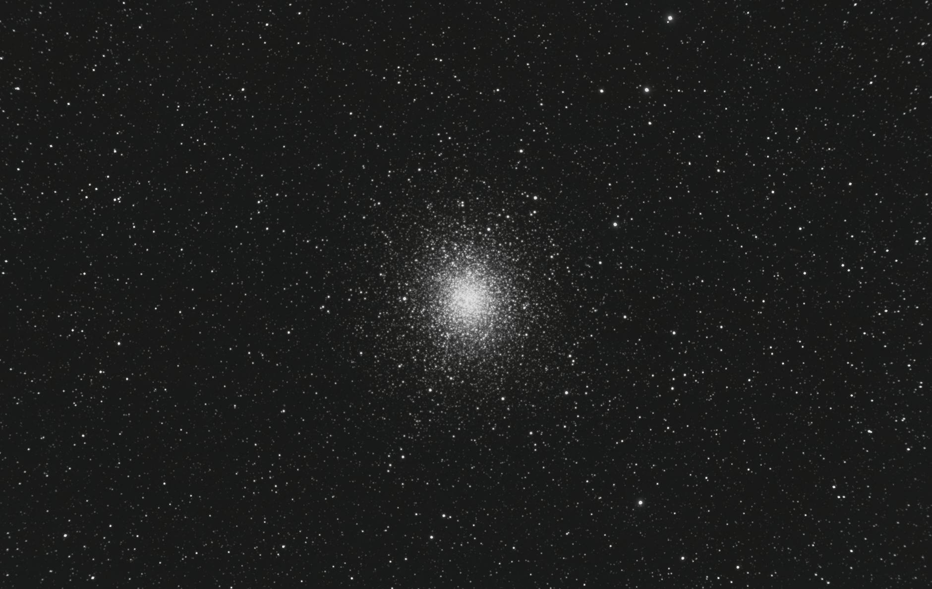 Black and white image of Omega Centauri, a globular cluster in a starry night sky.