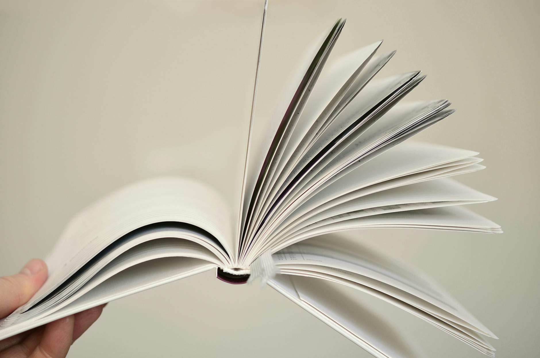 Close-up of an open book with pages flying, symbolizing knowledge and learning.