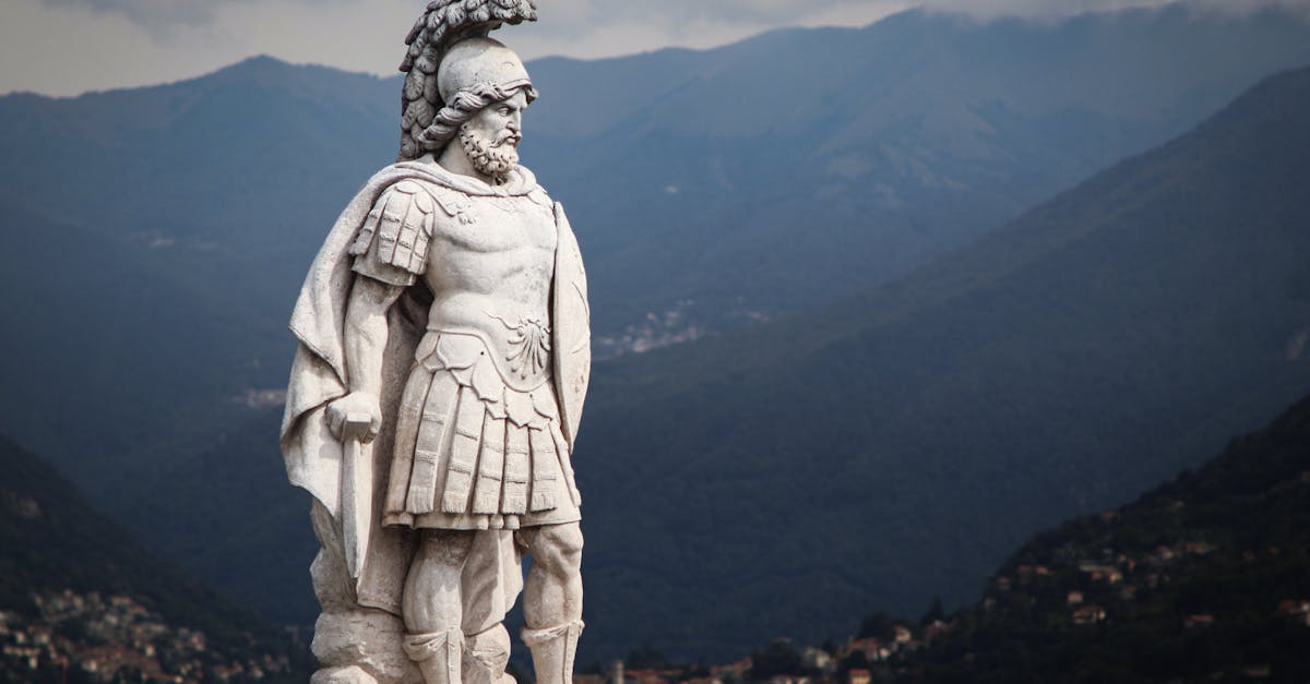 Majestic warrior statue overlooking the serene Lake Como with mountain backdrop.
