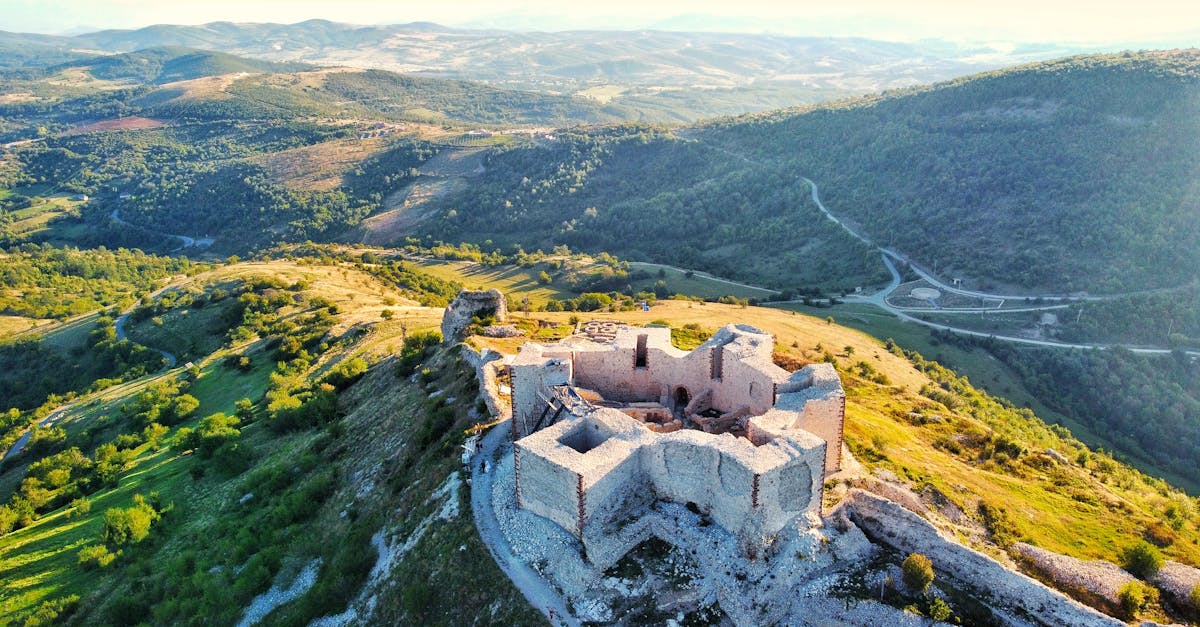 A stunning aerial view of the ancient Novo Brdo fortress in Kosovo, surrounded by lush hills.