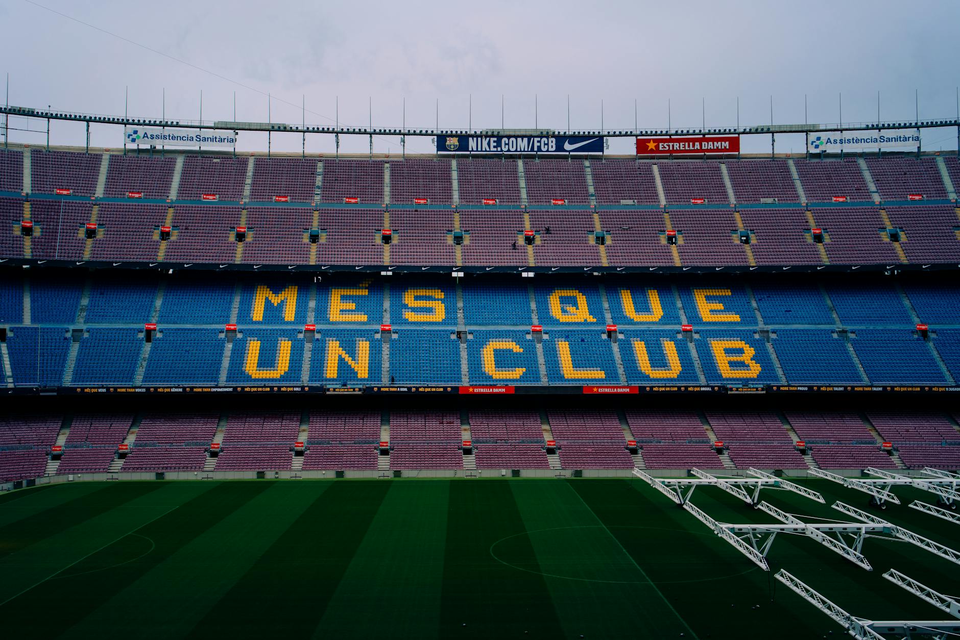 View of Camp Nou stadium seating displaying 'Mes Que Un Club' in Barcelona, Spain.