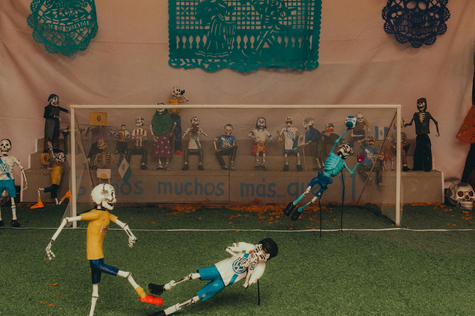 Artistic soccer display with skeleton figures celebrating Día de Muertos in Puebla, Mexico.