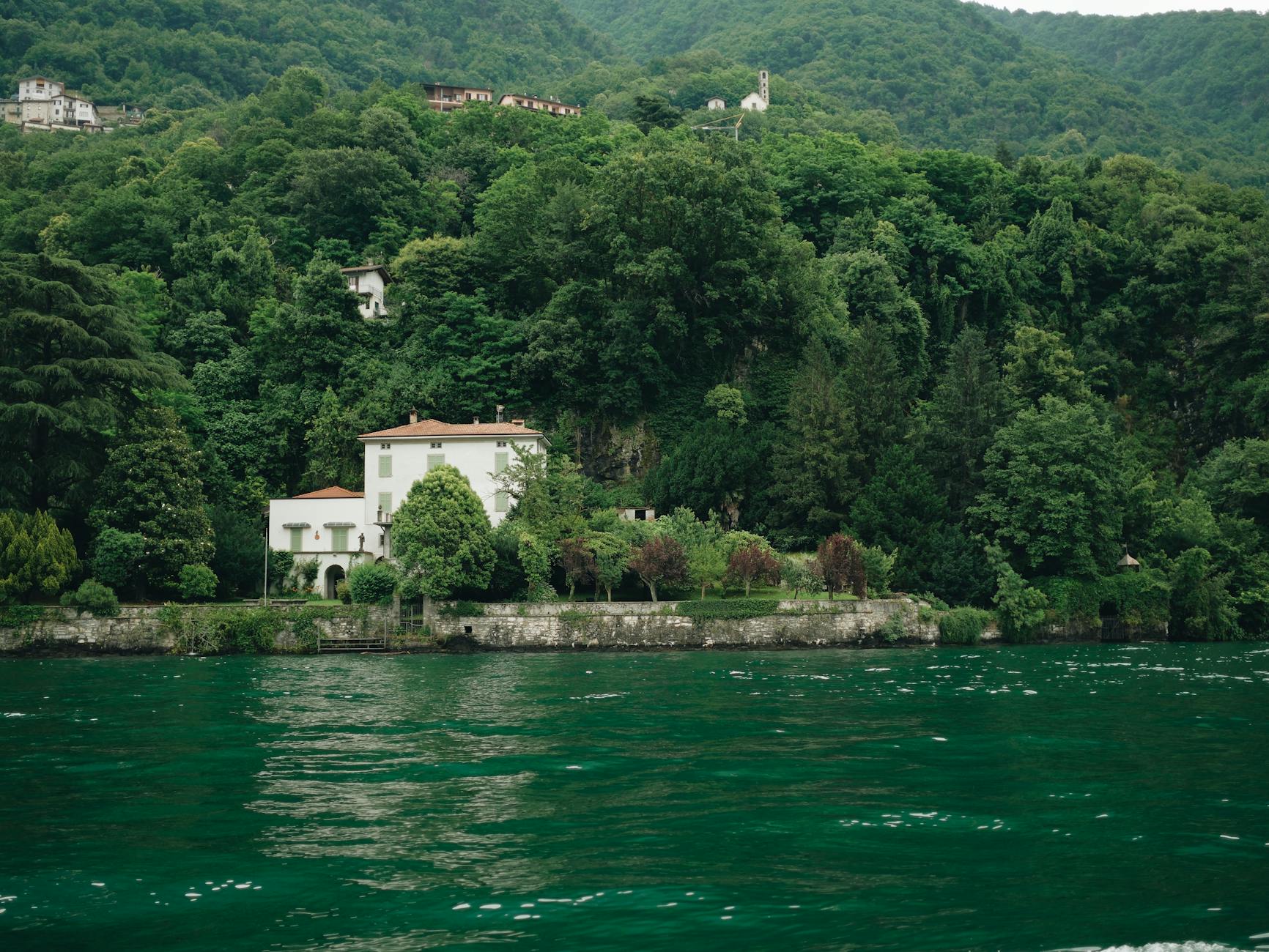 Charming villa by Lake Como surrounded by lush greenery in Lombardy, Italy.