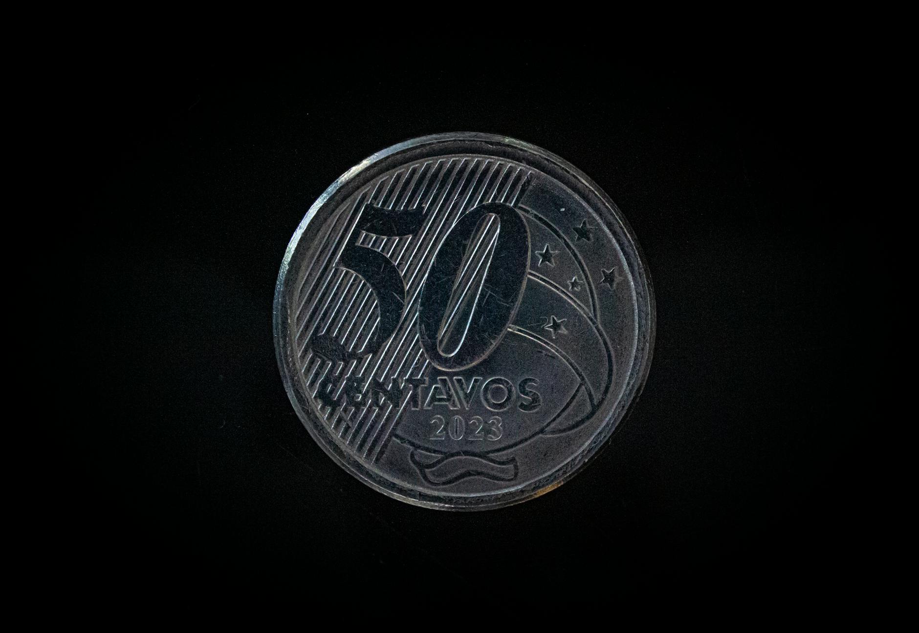 Detailed macro shot of a 50 Centavos coin from 2023 on a dark background.