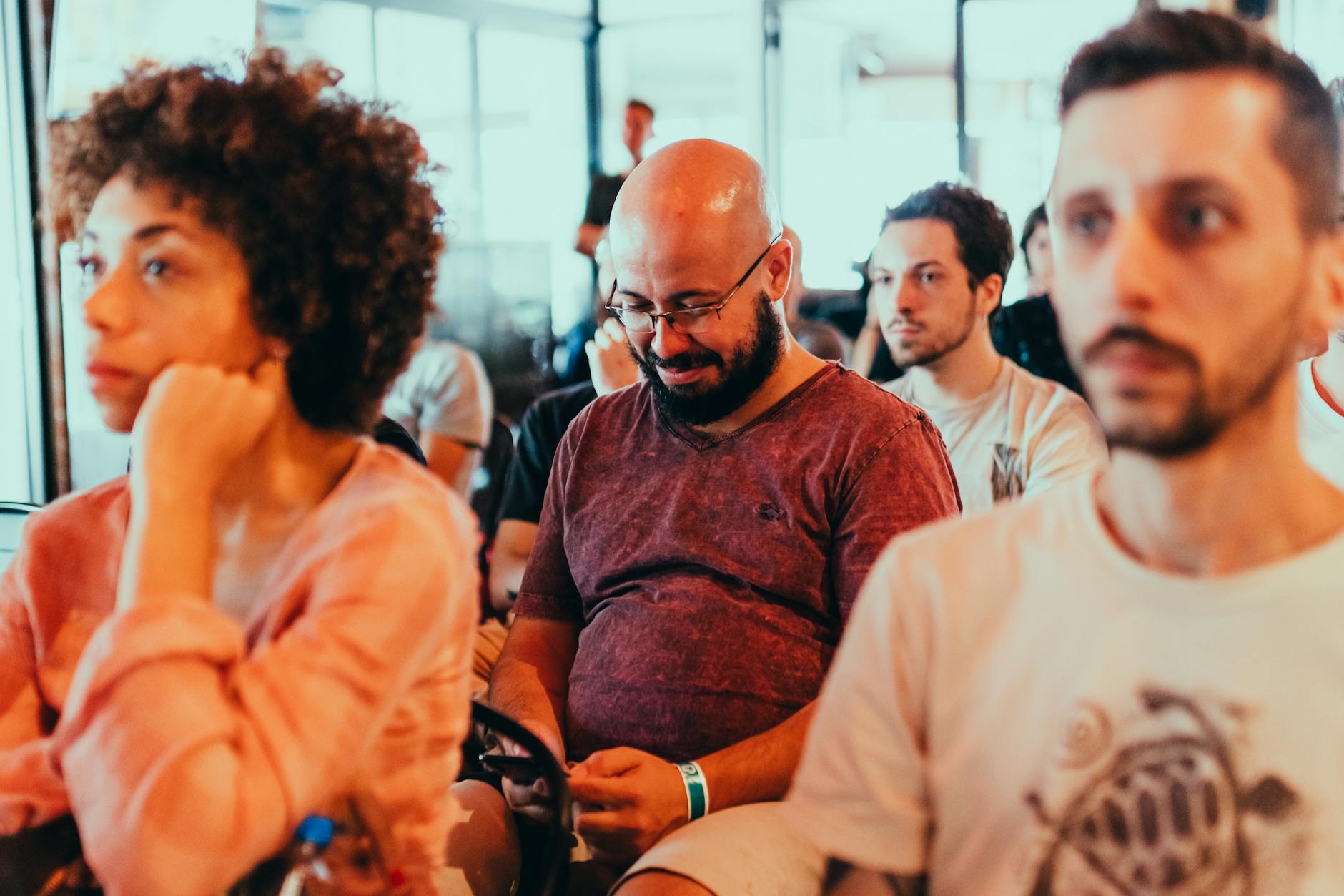 Engaged and diverse audience attending an indoor seminar with focus and interest.