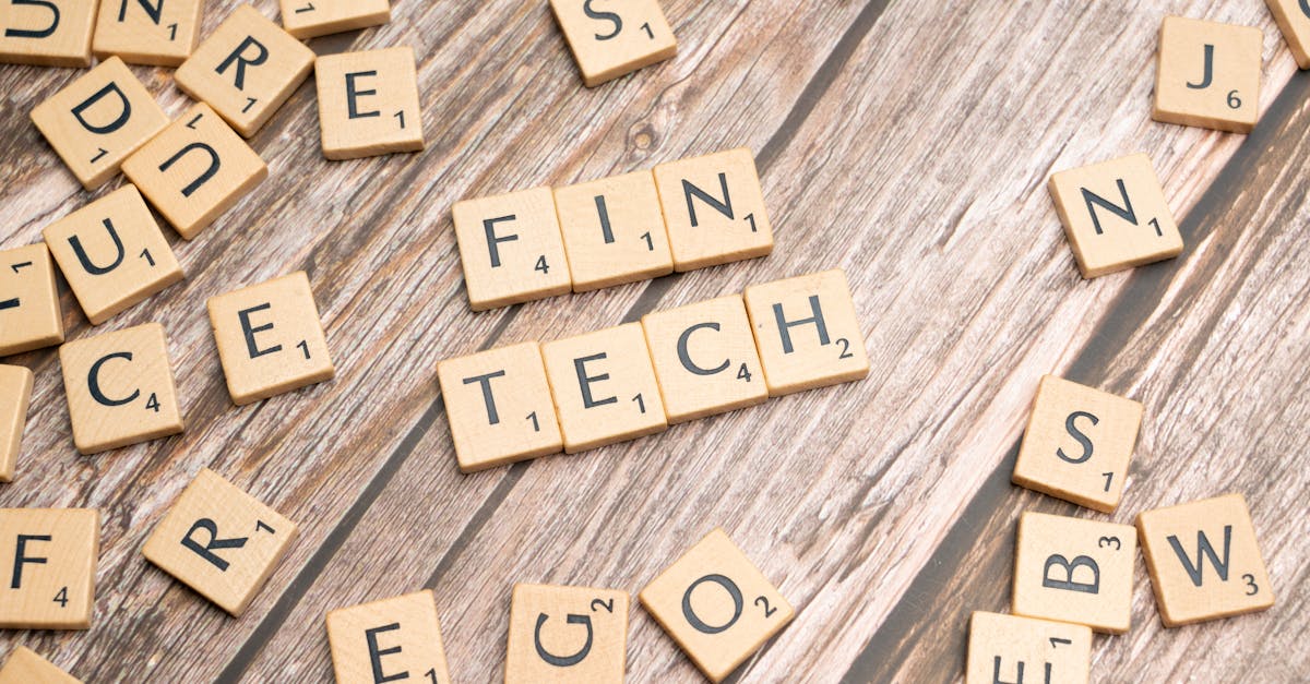 Fintech spelled out with wooden letter tiles on a rustic wooden background.