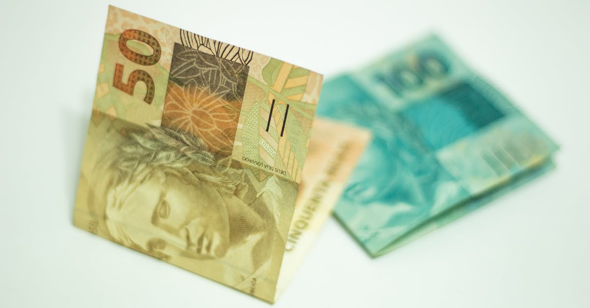 A close-up shot showcasing Brazilian banknotes, featuring 50 and 100 real bills.