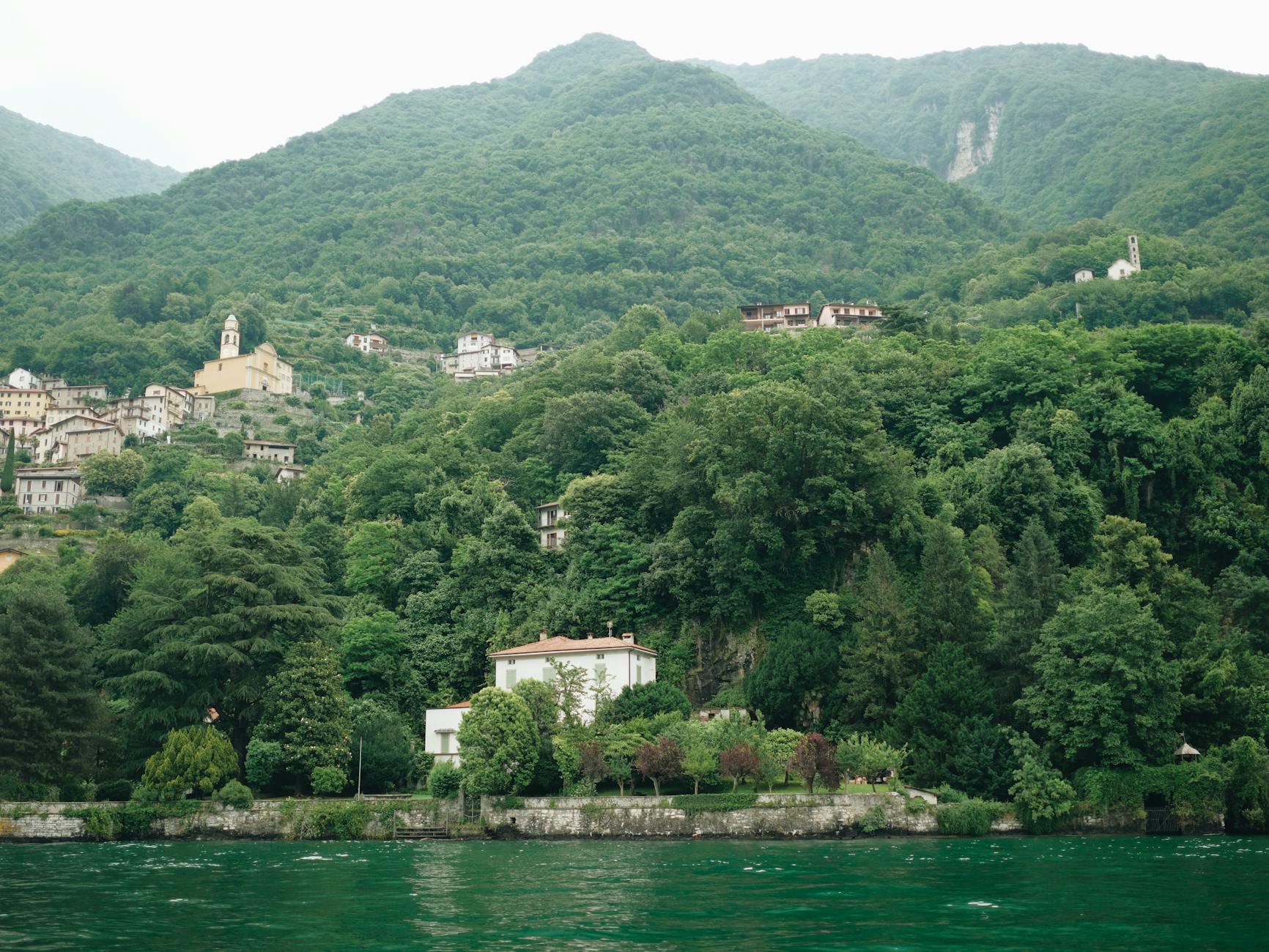 Picturesque landscape of lush hills and villas by Lake Como, Italy.