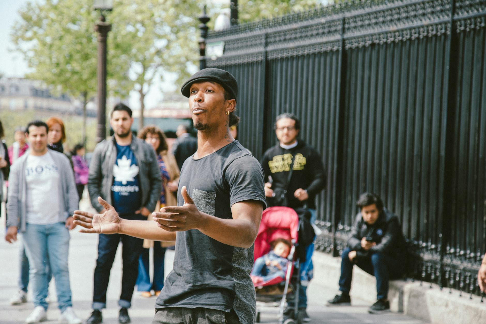 Street performer captivates an audience with lively dance moves in an urban outdoor setting.